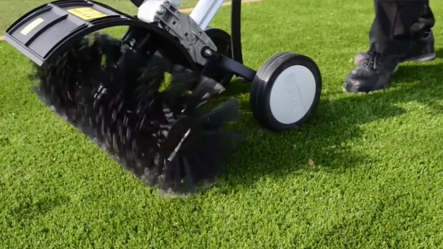 Power brushing artificial turf with silica sand infill during final grooming in Surprise AZ